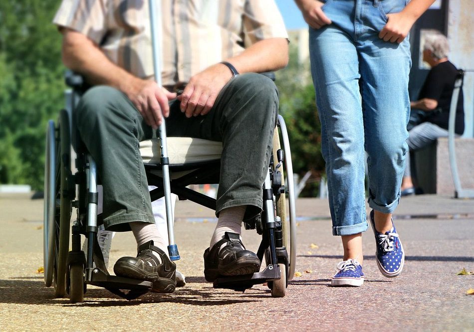 NDIS SIL support worker assisting a participant with daily living tasks in Brisbane