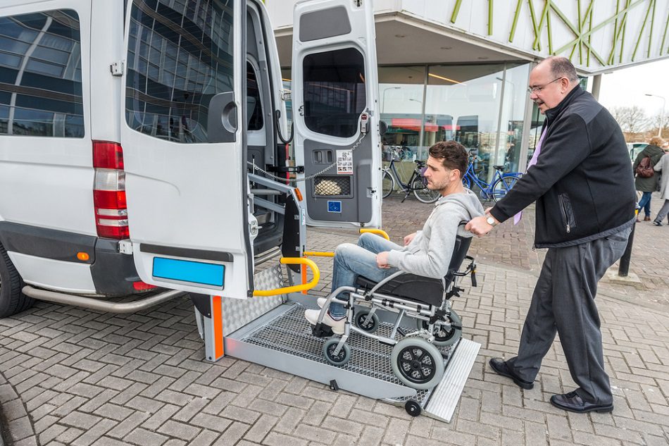 NDIS disability transport service in Brisbane Northside, support worker assisting participant into vehicle